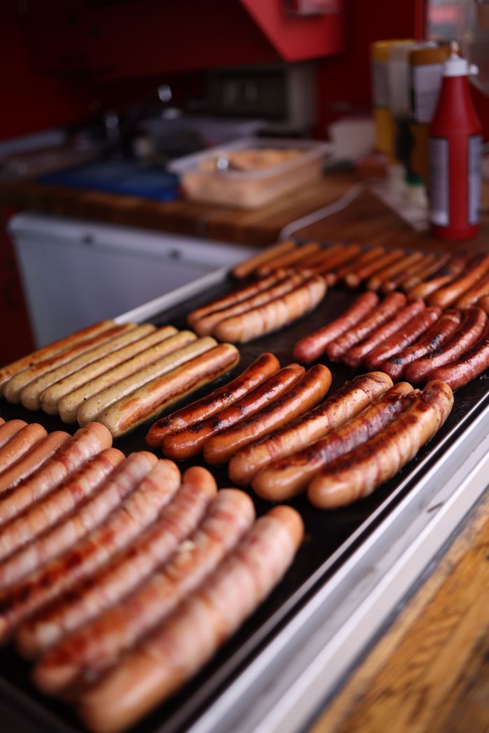 A variety of sausages grilled on a kitchen counter, ready for serving.